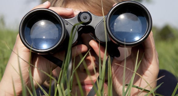 Photo of a woman looking through binoculars Photo of a woman looking through binoculars