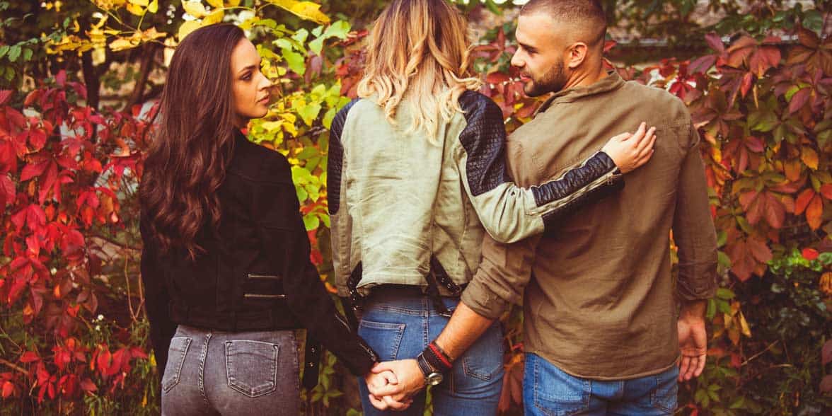 Photo of a man with two women