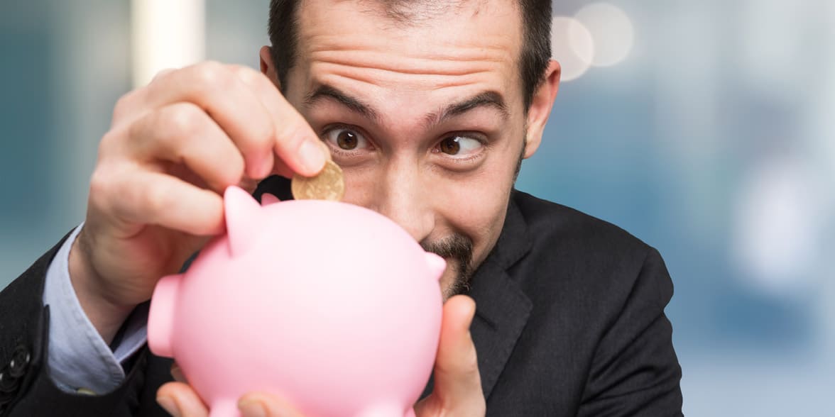 Photo of a man with a piggy bank